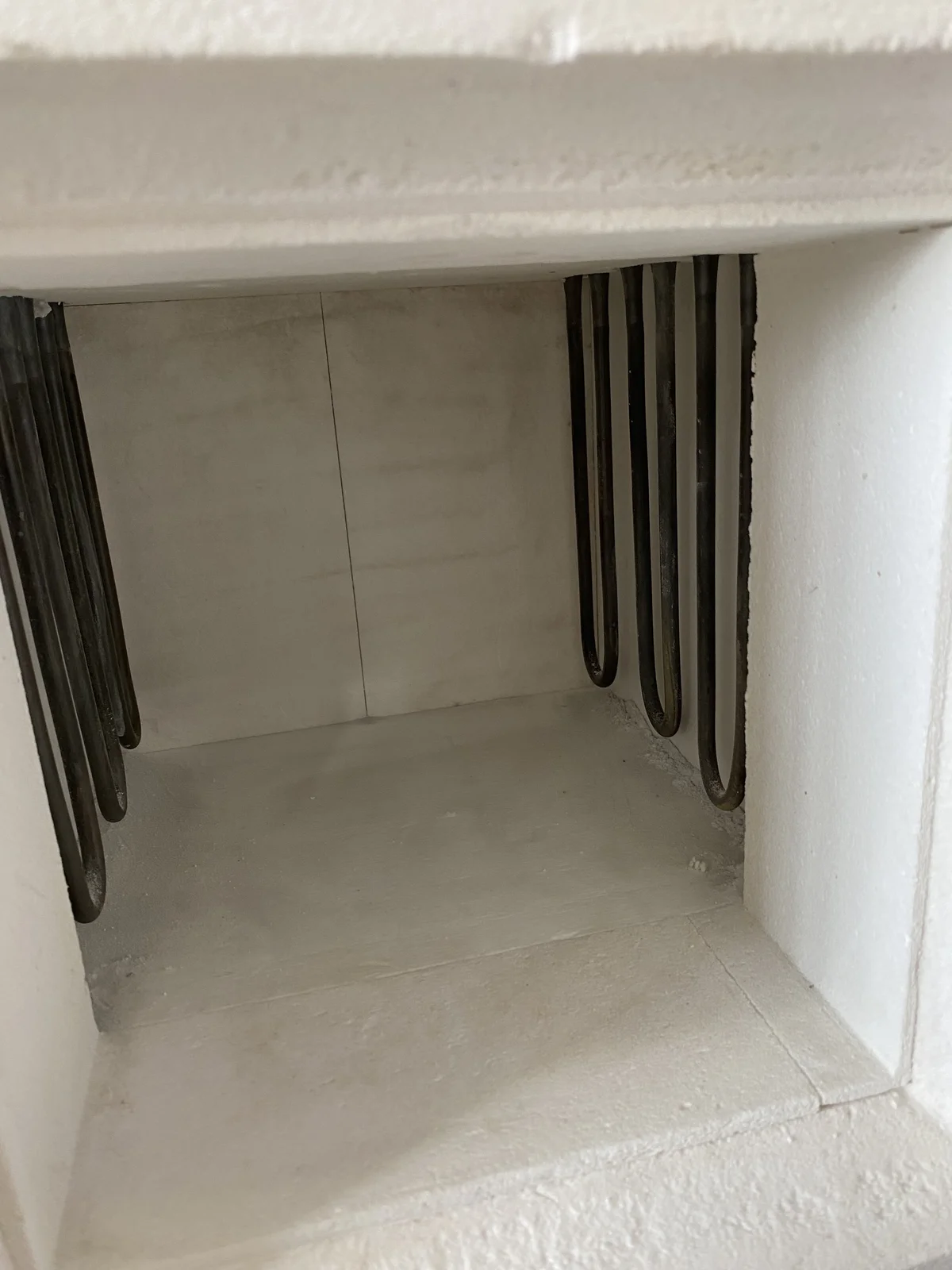 U-shaped heating elements installed along both sides of a pass-through box-furnace chamber