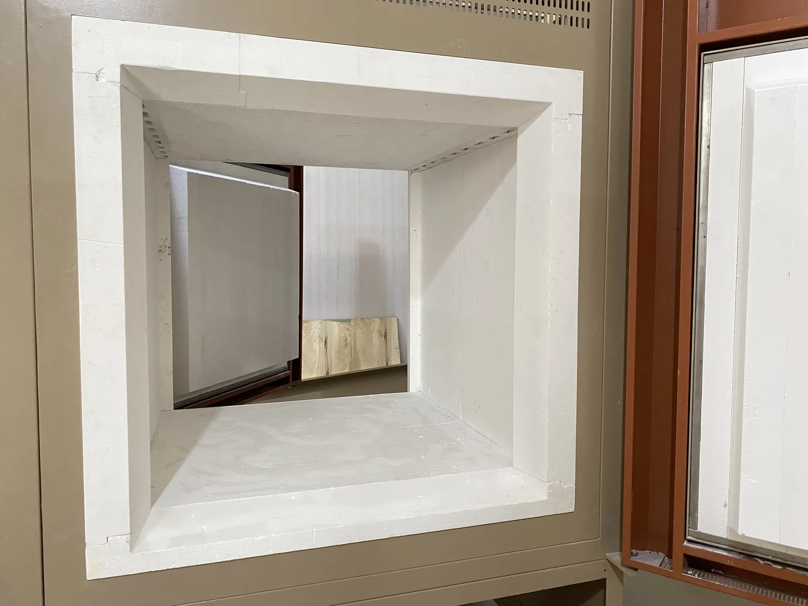 View through the insulated chamber toward the open opposite-side door