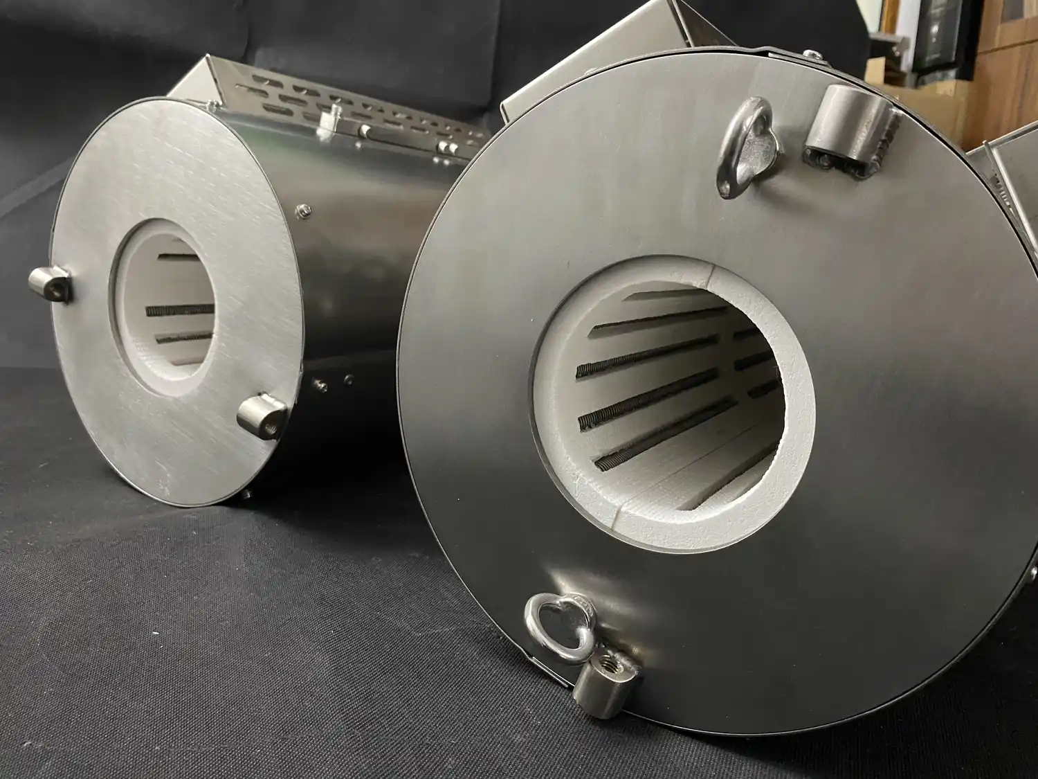 Two metal-shelled furnace chamber assemblies showing different internal heating-element layouts