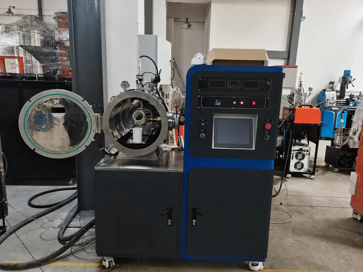 Open vacuum induction melting system with sealed vessel, induction hot zone and separate controls